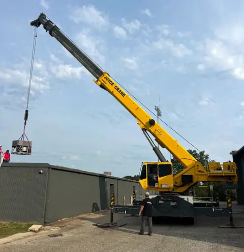 Commercial HVAC installation using a crane