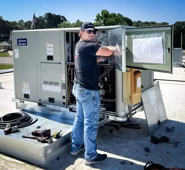 Humphrey Air Conditioning technician installing a brand new commercial American Standard unit on a rooftop