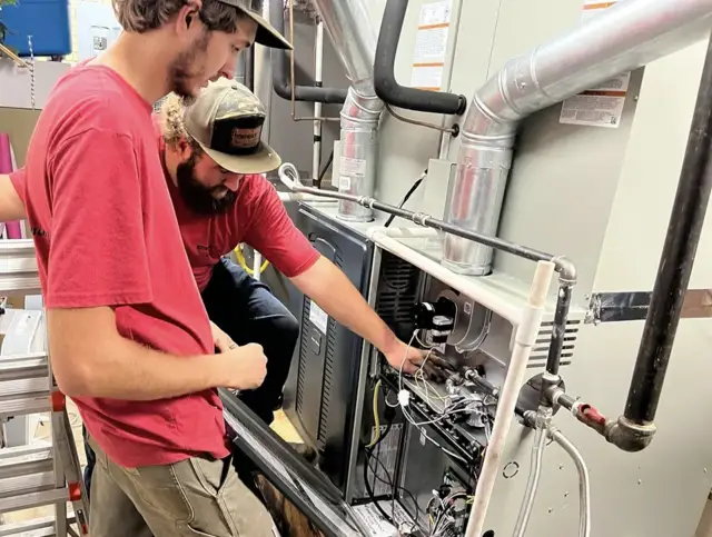 Technicians performing maintenance on a system